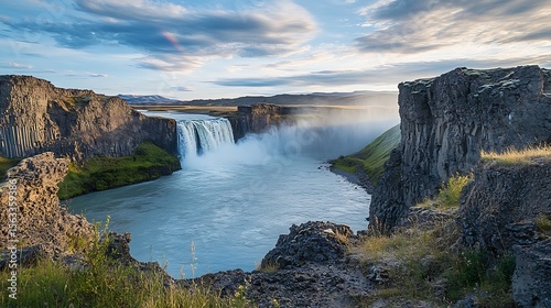 Majestic Waterfall Cascading Over Basalt Cliffs In Iceland