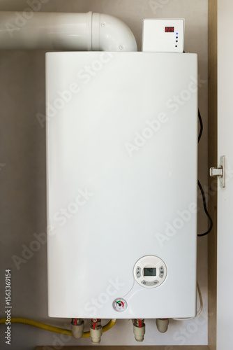 Installed household gas boiler hanging on the wall