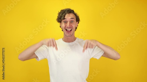 Confident man looking down pointing with both index fingers, nodding in agreement bold and expressive visual ideal for advertising, customer service, lifestyle branding, World Kindness Day campaigns