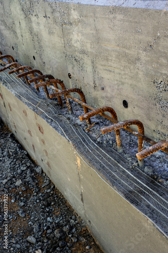 Close-up of a concrete construction joint with rebar dowels.