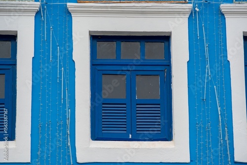 Vibrant Blue Shuttered Window on Historic Building