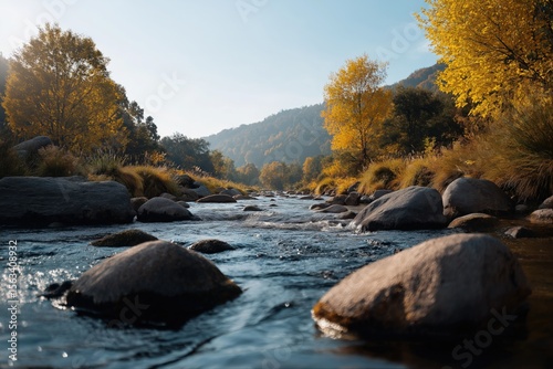 Tranquil autumn stream with golden trees and smooth rocks under clear blue sky