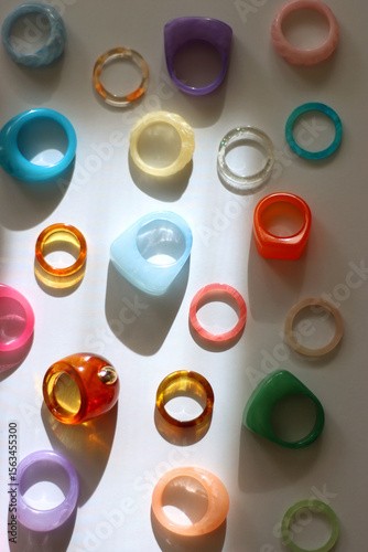 Collection of colorful plastic rings on white background. Top view.