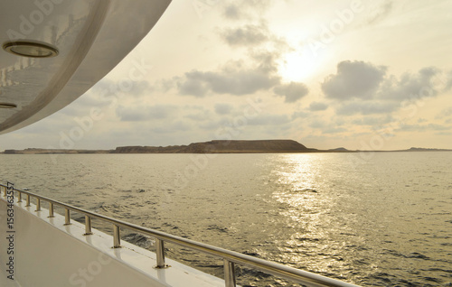 View from the yacht on the sparkling sea and the desert coast of the Red Sea