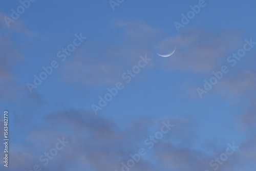 half moon floating on blue sky in twilight background 