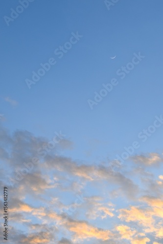 half moon floating on blue sky in twilight background 