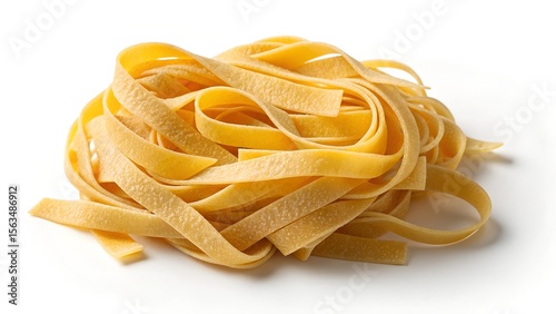 Close up of a nest of uncooked yellow fettuccine pasta with a light dusting of flour on a white background