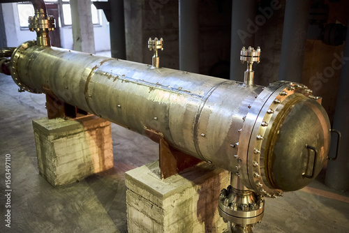 Industrial refinery 1 pass heat exchanger chiller with flanges and valves inside industrial workshop. Interior of enterprise industrial background with copyspace.