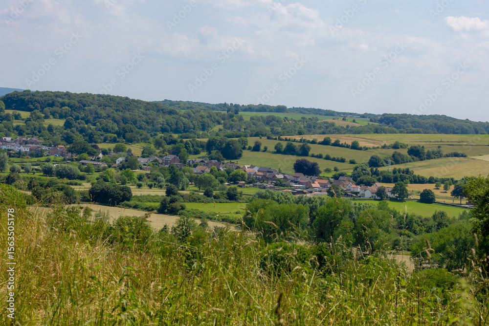 Obraz premium Summer landscape, The terrain of Schaesberg (mountain) with a small town villages on hillside, Strucht is a hamlet in the Dutch province of Limburg, Municipality of Valkenburg aan de Geul, Netherlands