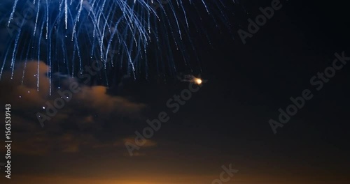 Spectacular blue fireworks explode in the night sky