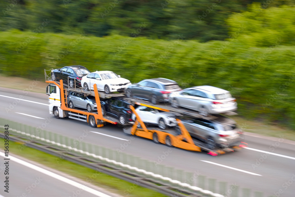 Samolepka Fast Moving Car Transporter Truck Carrying Multiple Vehicles in Blurred Motion