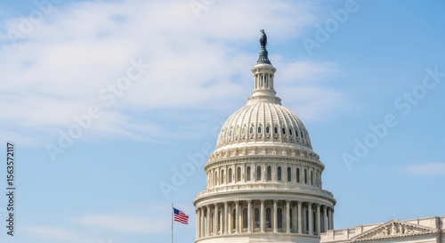 Iconic United States Capitol Building dome and flag under a clear blue sky