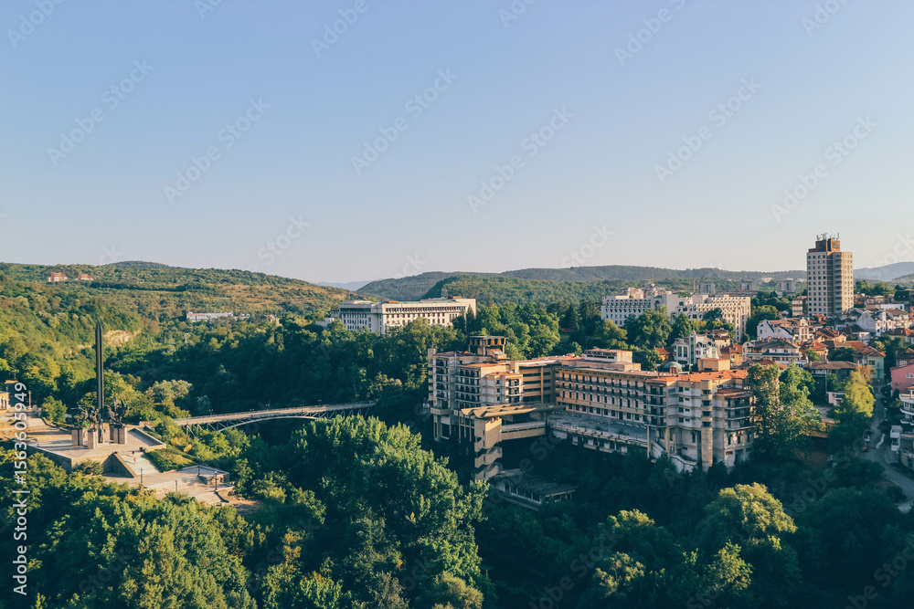 Fototapeta premium panorama of the old town of veliko tarnavo bulgaria with green forest in hot summer day