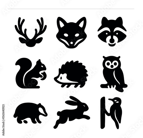 Woodland Animal Icons. Solid, filled icons set of woodland animals: deer antlers, fox face, raccoon mask,