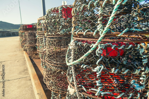 A stack of lobster pots on a jetty photo