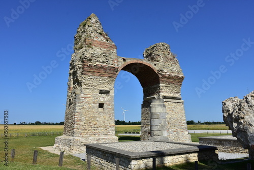 ruins of triumphal arch of Roman city in fields near capital city Vienna in Austria