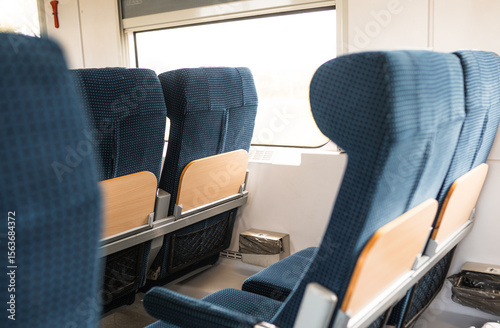 Image with the interior of a european  train. A modern train with comfortable chairs.