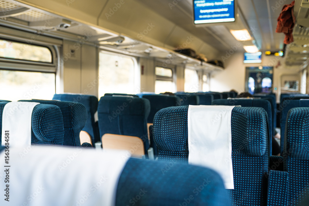 Fototapeta premium Image with the interior of a european train. A modern train with comfortable chairs.