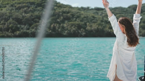 Woman relaxing on a sailboat, embracing tranquility on a tropical island vacation in the caribbean