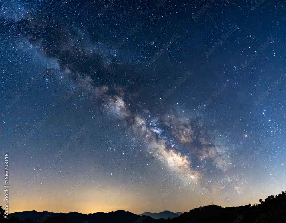 Fototapeta premium Milky way panorama over mountains