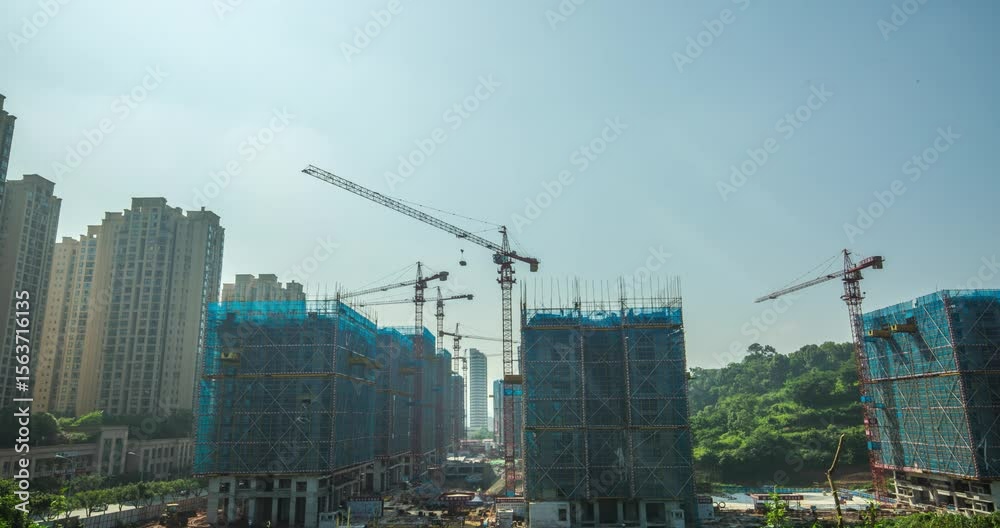 Tower crane operates at construction site as buildings rise under clear sky Tower crane operates at construction site as buildings rise under clear sky