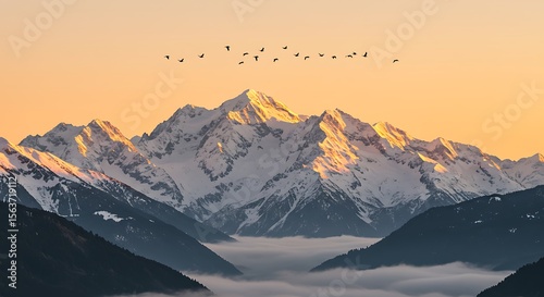 Majestic Sunrise over Snow-Capped Mountains with Flock of Birds