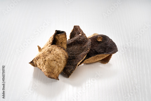 Close-up of a pile of vintage tangerine peel on a white background