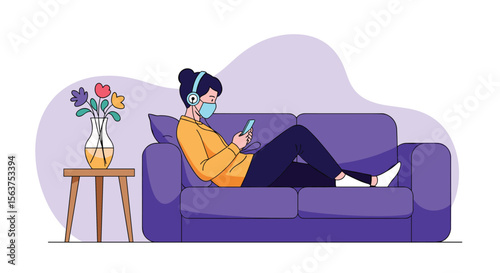 Young woman in face mask listening music on headphones while using smartphone on sofa with flowers on side table in a room