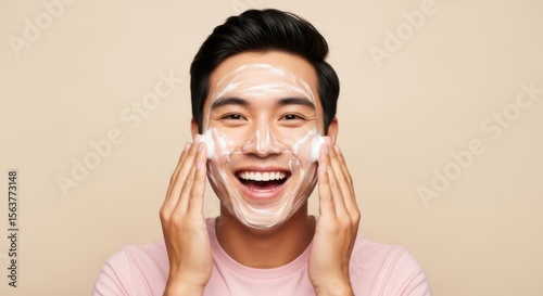 Handsome man enjoying a refreshing facial cleanse