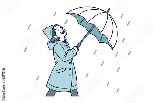 Joyful person in a raincoat holding an umbrella smiling up at the falling rain embracing the weather