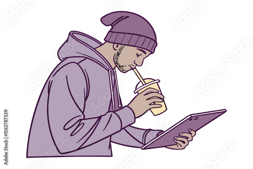Young man wearing a purple beanie and hoodie focused on his tablet while enjoying a beverage through a straw