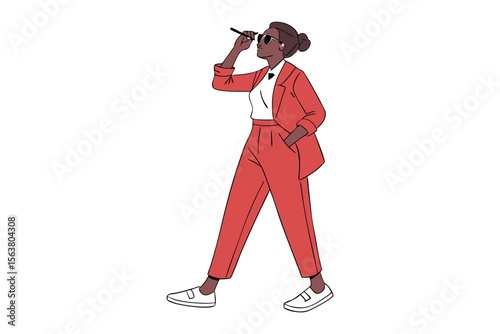 Stylish woman in a red suit and sunglasses confidently adjusts her eyewear while posing with her hand in her pocket