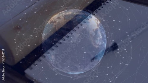 Network lines rising over notebook causing holographic globe spinning into nodes linking data