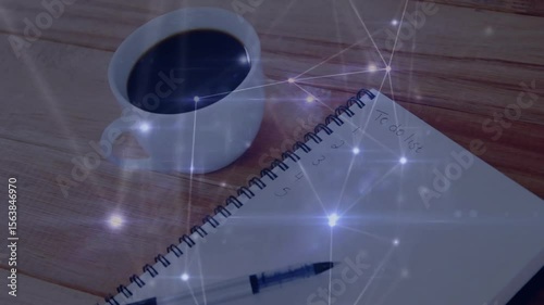 Overhead desk initiating network fading in flaring notebook sparking dimming out over coffee mug