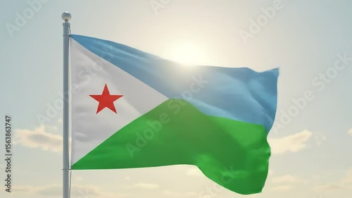 The Djiboutian flag waving gently in the morning breeze, centered against a pale, cloudless sky.