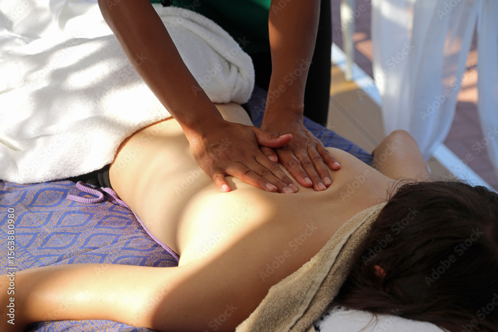 Obraz premium woman covered with white towels during massage session in exclusive luxury spa during cruise