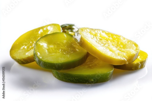 Isolated image of several pickle slices, also known as dill pickle chips or pickled cucumber, arranged on a clean white background.