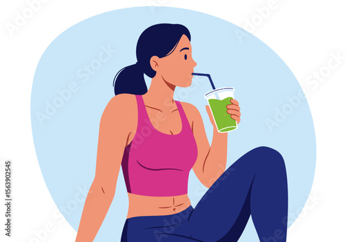 Woman drinking a green smoothie wearing pink top  blue leggings Light blue backdrop