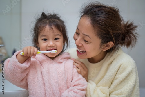 Toddler Routine: Mom and Daughter Brushing Teeth Together for Fresh Breath and Hygiene