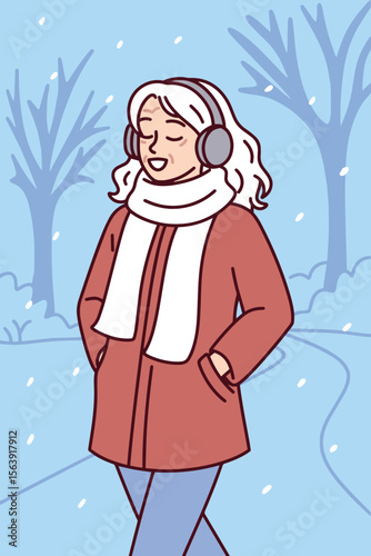 Elderly woman walks through snowy park alone in warm coat and red scarf during cold winter day