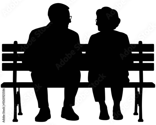 Silhouette of elderly couple sitting on park bench
