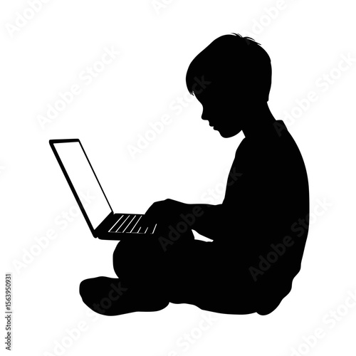 Child using laptop while sitting on the floor in silhouette  