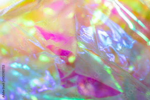Fotografi Close-up of iridescent crinkled cellophane foil with vibrant multicolor reflecti