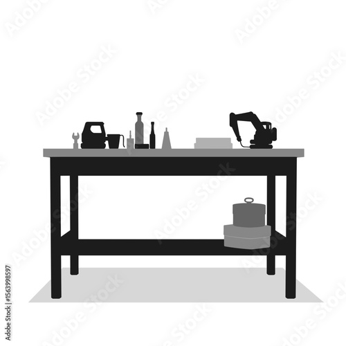 Construction tools and equipment on workbench.  Variety of building materials and tools neatly arranged on sturdy worktable.  Detailed image showcasing construction essentials