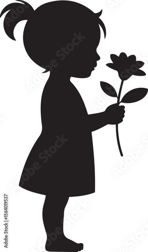 Silhouette of a young child holding and smelling a flower