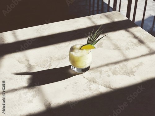Creamy pina colada cocktail with lime on neutral stone background, top view.