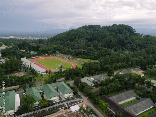 Aerial view stadium with green hill.