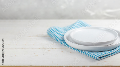 Table setting. White plates on a white table. Copy space