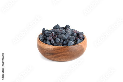 Ripe honeysuckle berries in a bowl on a white background.