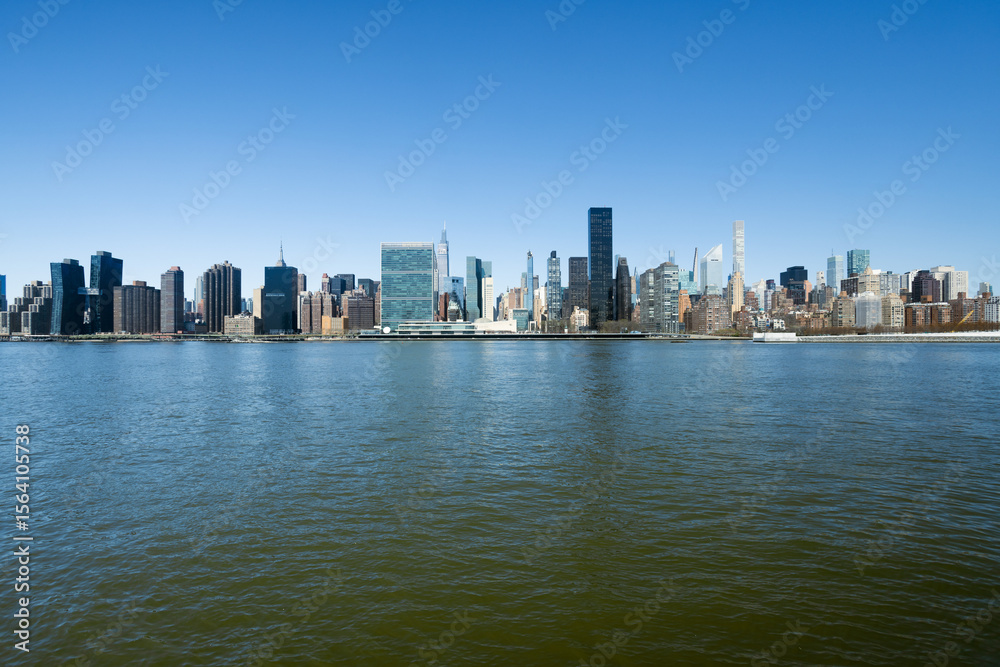 Naklejka premium Urban Skyline Across Water 